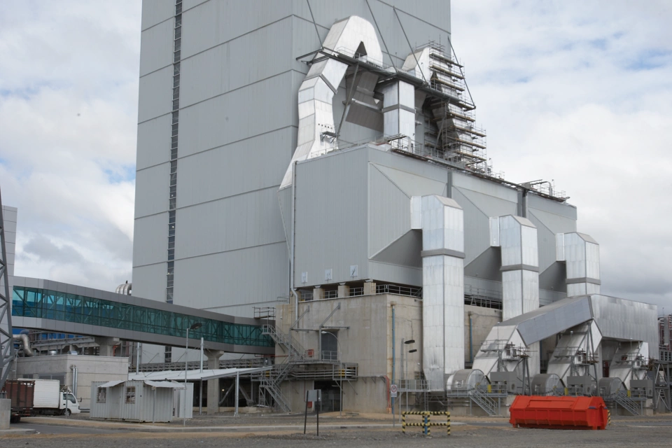 Boiler unit at a pulp and paper mill during the day. Vertical format.