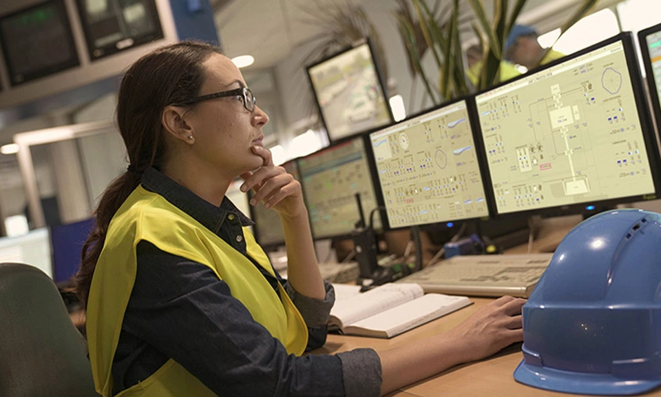 women engineer working in control room with HMI screens