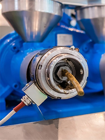 Close up: blue pet food extruder machine: mixed feed production line at factory, plant, exhibition, trade show. Farming, extrusion technology equipment, agriculture industry, animal husbandry concept