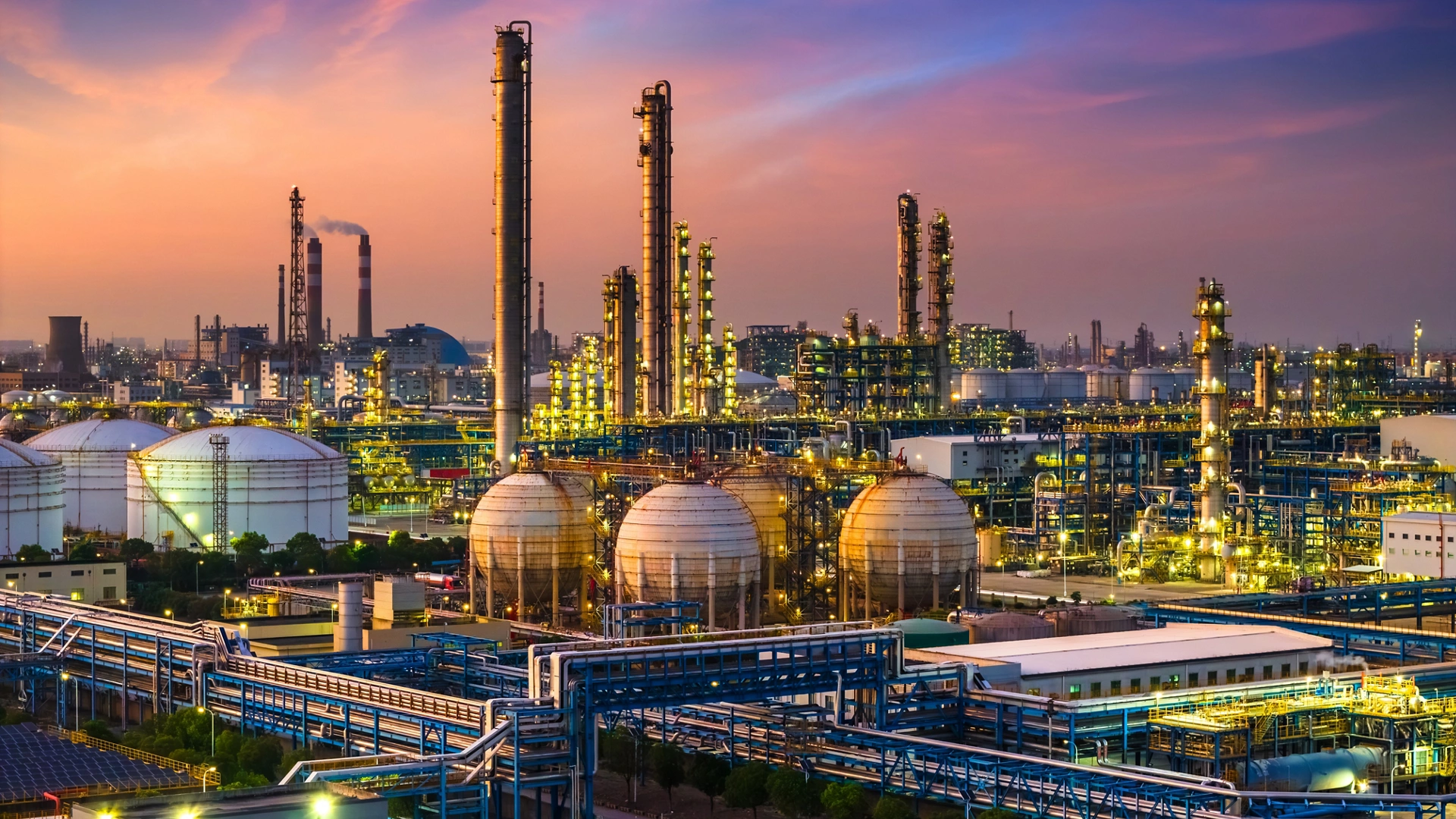 Oil refinery and chemical plant in large industrial area at sunset