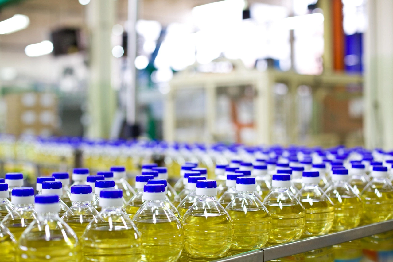 Factory for the production of edible oils. Shallow DOFF. Selective focus. The focus is on the bottle in the center down.