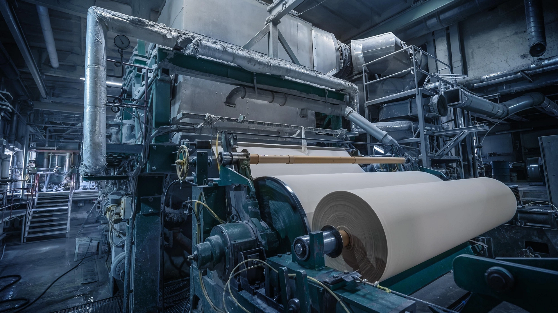 Paper production machine in wastepaper recycling factory. Paper and pulp mill.