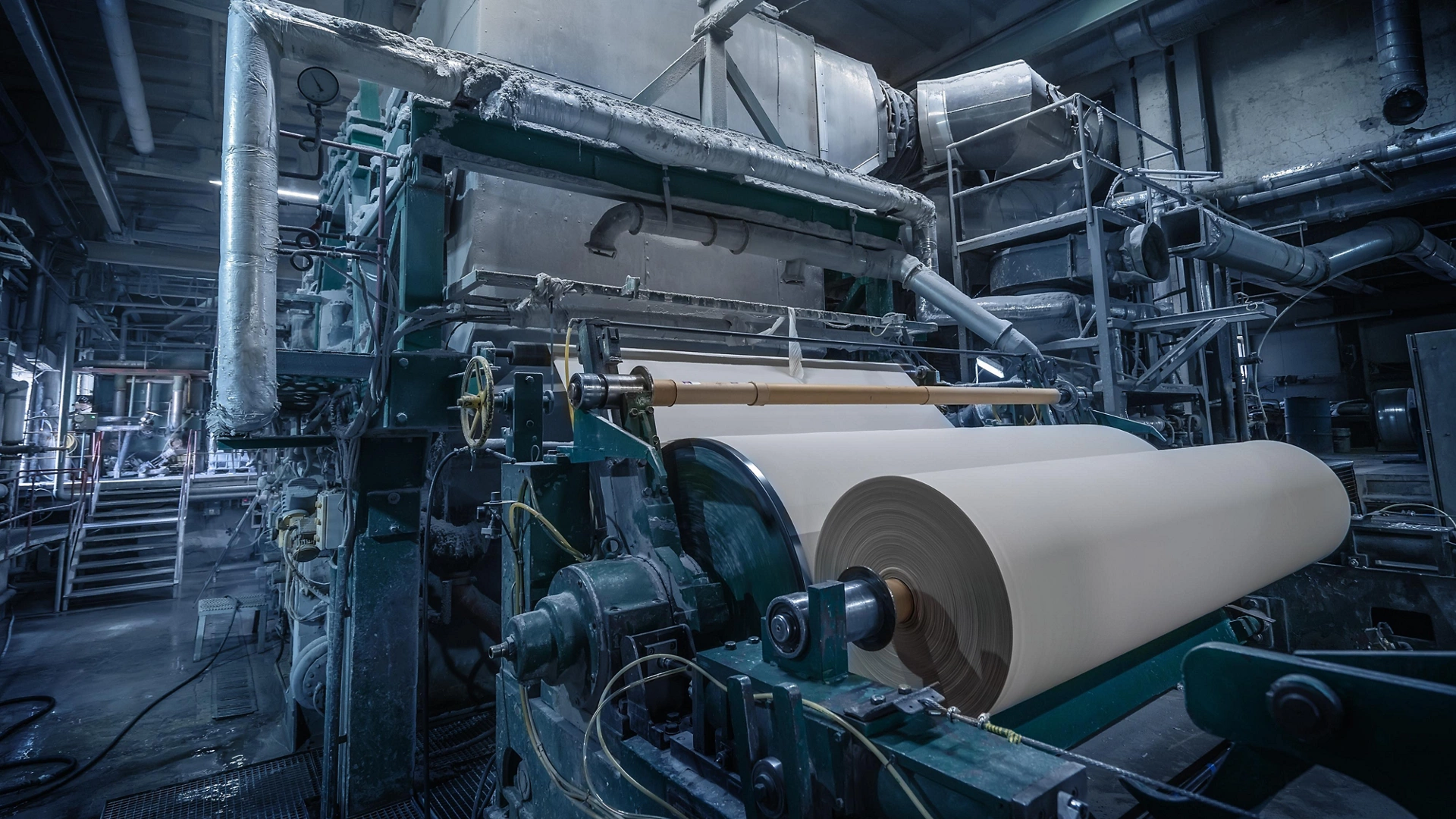 Paper production machine in wastepaper recycling factory. Paper and pulp mill.
