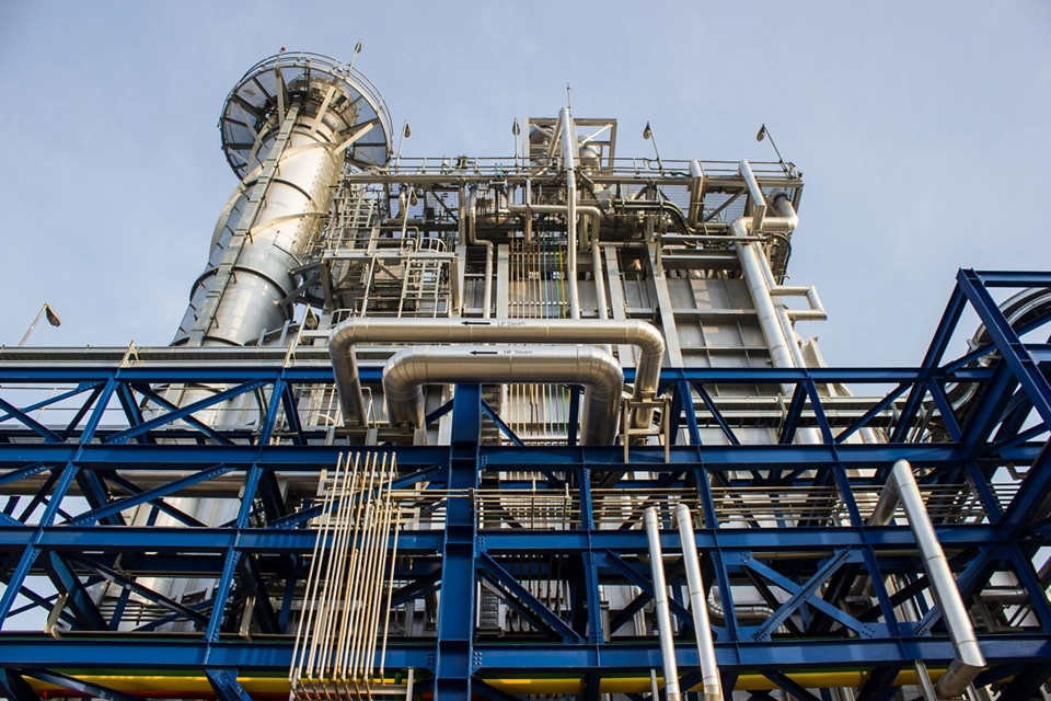 Close-up view of heat recovery steam generator structure with pipes and steel framework at a power plant