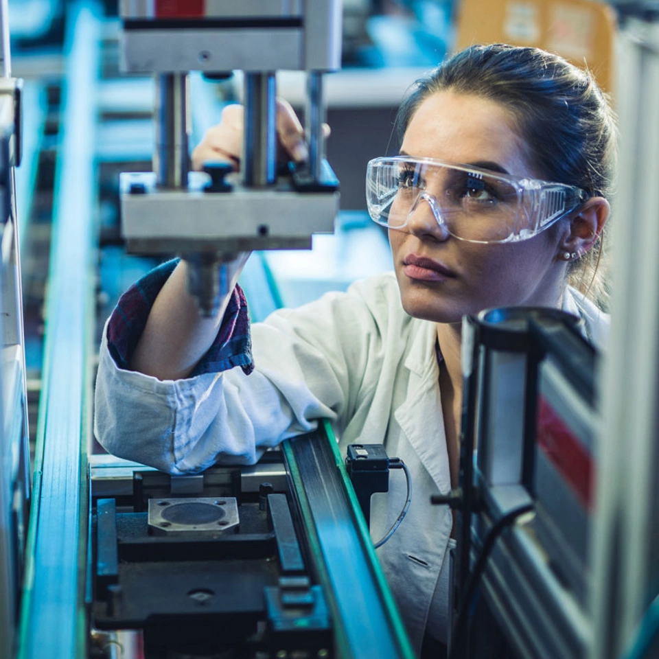 Woman in lab coat working with equipment